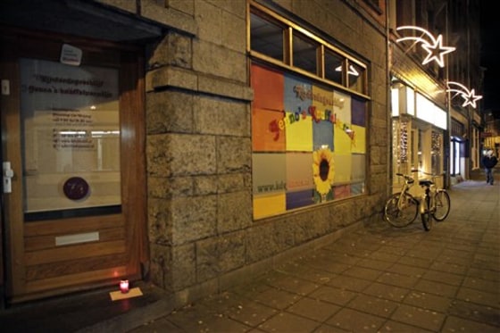 A lone candle with a note stands Sunday in the doorway of a daycare center in Amsterdam, where a man suspected of abusing preschool children was employed. Parents of dozens of preschool children in Amsterdam have been warned their children may have been abused by a baby sitter in one of the worst sexual abuse cases to come to light in the Netherlands. Authorities say a 27-year-old suspect was arrested after a tip from U.S. authorities about child pornography. The man's computers have been seized and he has confessed to dozens of sex crimes at two Amsterdam daycare centers over the past 18 months, police chief Herman Bolhaar said at a press conference Sunday.